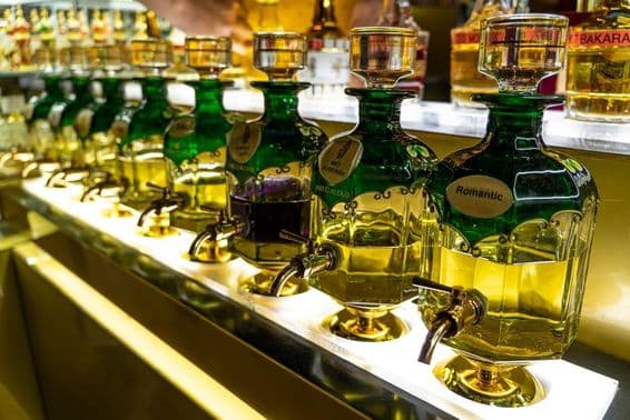 Gros plan sur des bouteilles d'huiles essentielles utilisées pour la parfumerie alignées au marché de Souk Madinat Jumeirah.