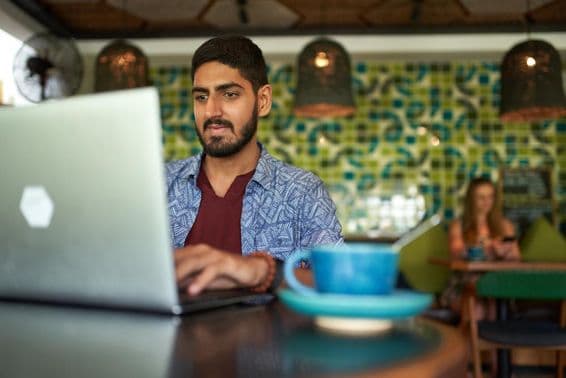 Homme indien travaillant dans un espace de coworking tendance.