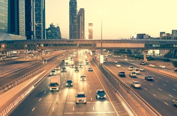Gratte-ciels, routes, et pont sur la route Sheikh Zayed à Dubaï la nuit.