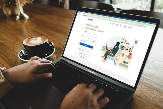 Une personne ouvrant la page de connexion LinkedIn sur un MacBook.