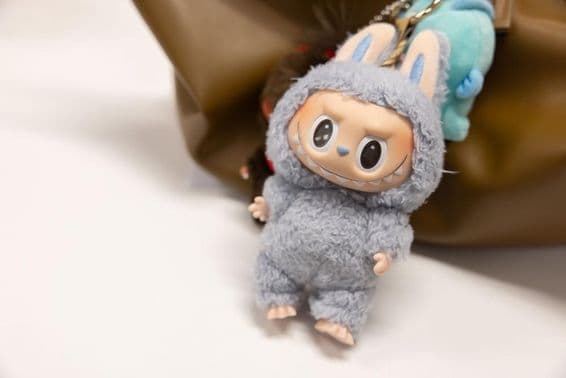 Vue du célèbre Popmart Labubu sur le sac d'une femme.