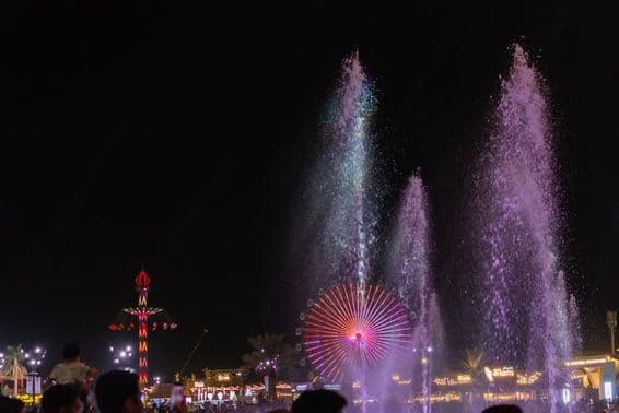 La scène nocturne vibrante au Festival Sheikh Zayed avec des fontaines d'eau.