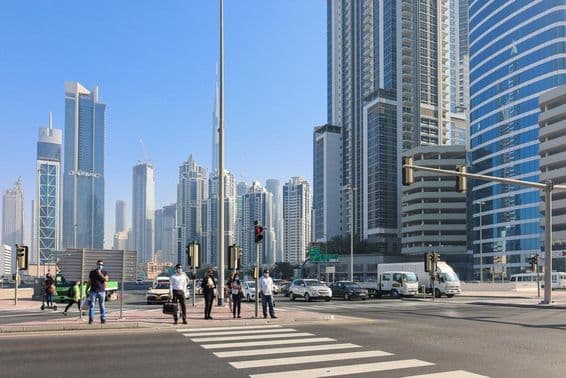 Des gens traversant un passage piéton dans le quartier d'affaires de Dubaï.