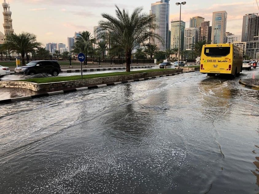 Trafic circulant sur une route urbaine inondée à Dubaï.