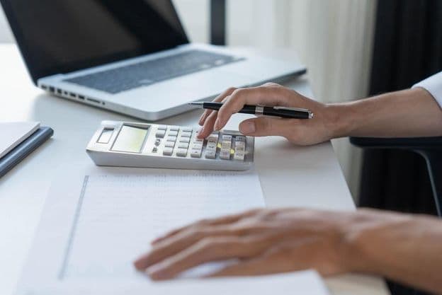 Comptable calculant sur une calculatrice.